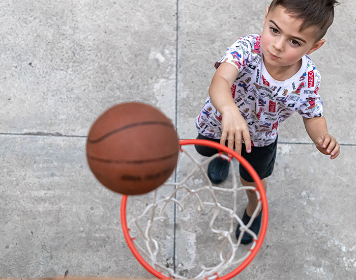 Carnival Games, boy playing mini-basketball